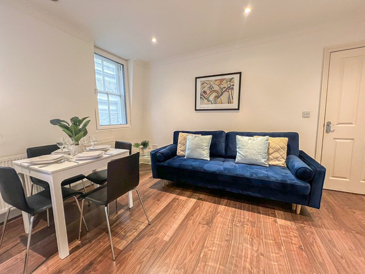 Blue sofa beside a dining table in the living room