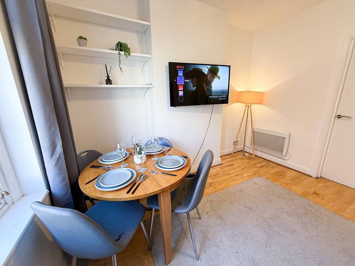 Dining table beside the living-room window in Hackney